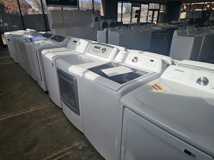 A row of washers and dryers in a room