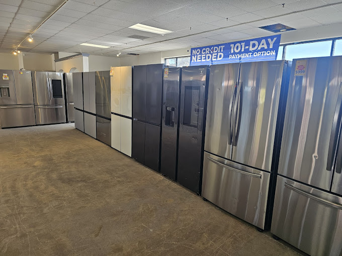 A row of refrigerators in a large room