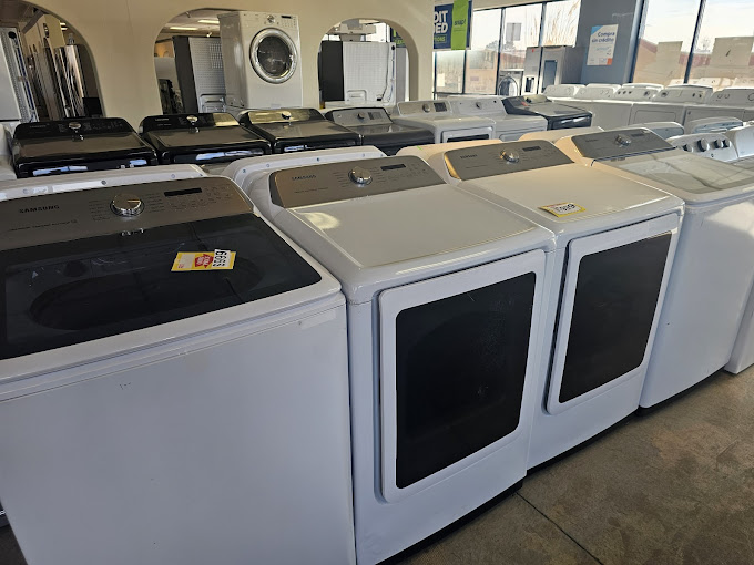 A row of washers and dryers in a store