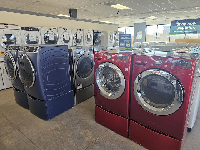 A row of washers and dryers in a store